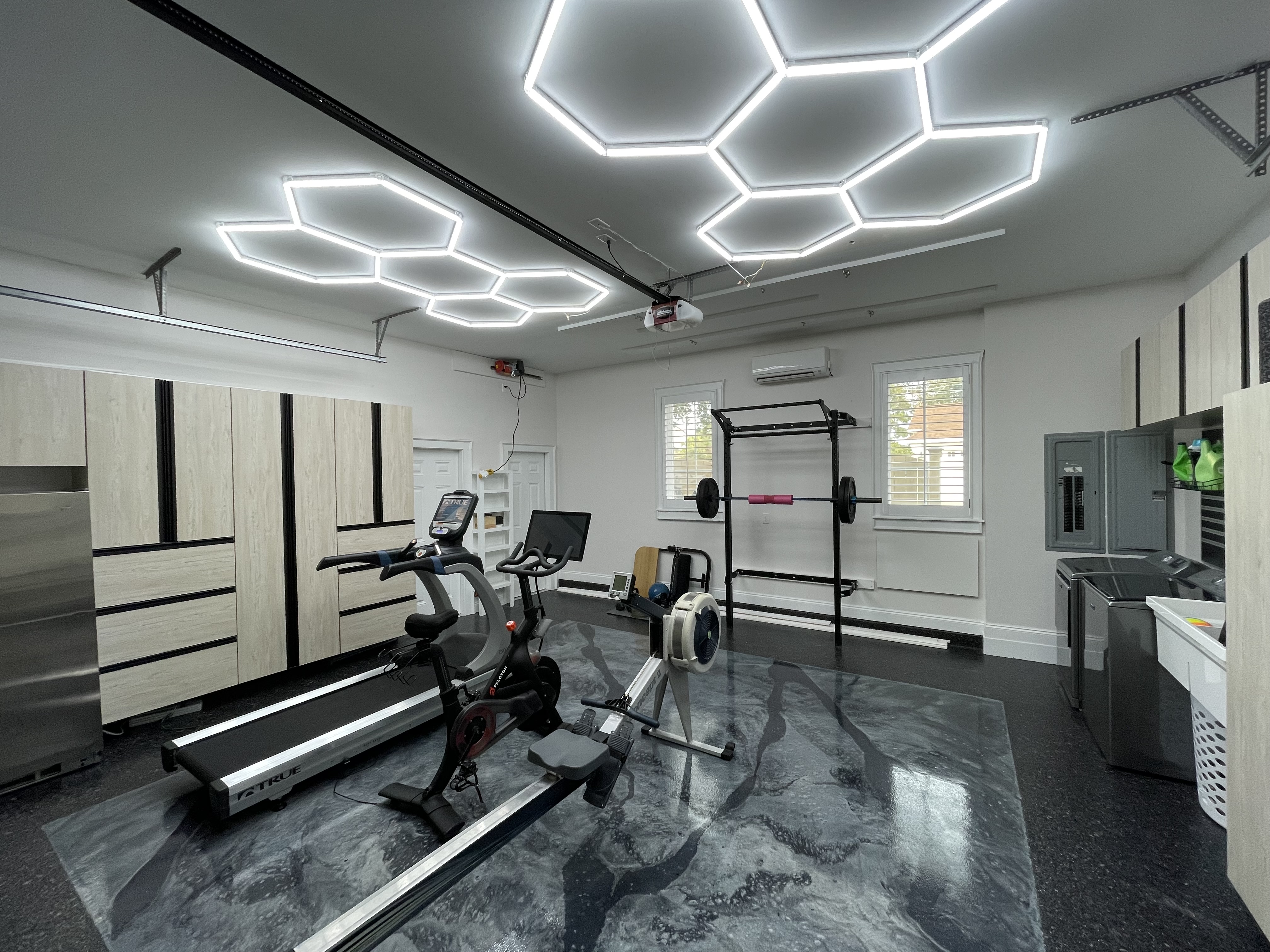 Garage Home Gym with Treadmill, Bike, Rower, Weight Rack, and Epoxy Flooring